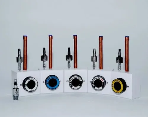 Five BS medical gas outlets on white boxes, each with the colour ring of its gas.